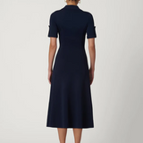 Navy blue dress worn by a model on a white background