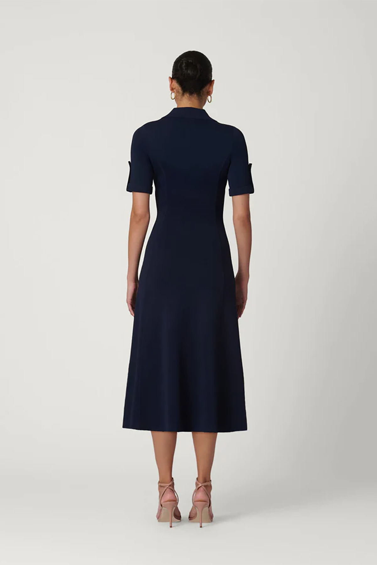 Navy blue dress worn by a model on a white background
