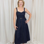 Indigo midi dress with a sweetheart neckline, corset-inspired seams, and a belted waist