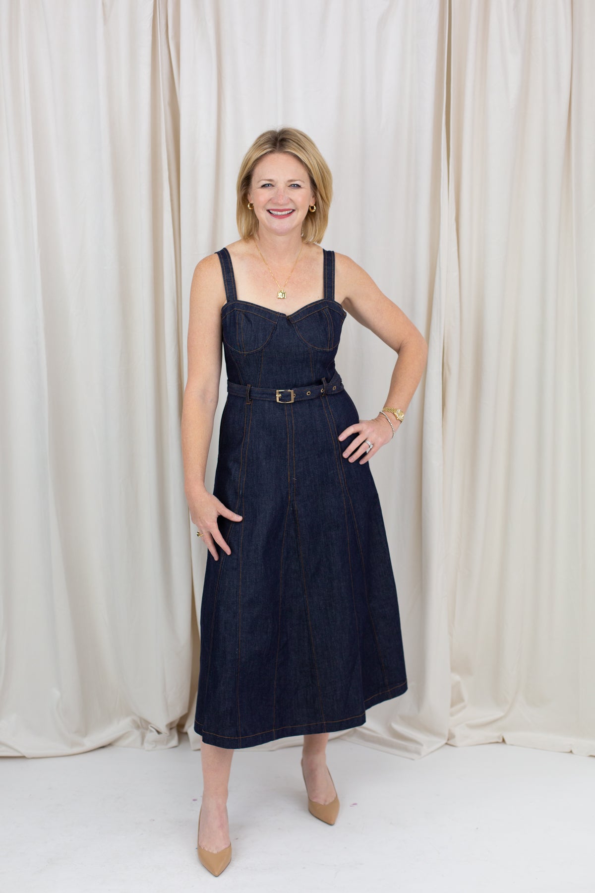 Indigo midi dress with a sweetheart neckline, corset-inspired seams, and a belted waist