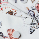 White ceramic plates with colorful butterfly designs on a white background