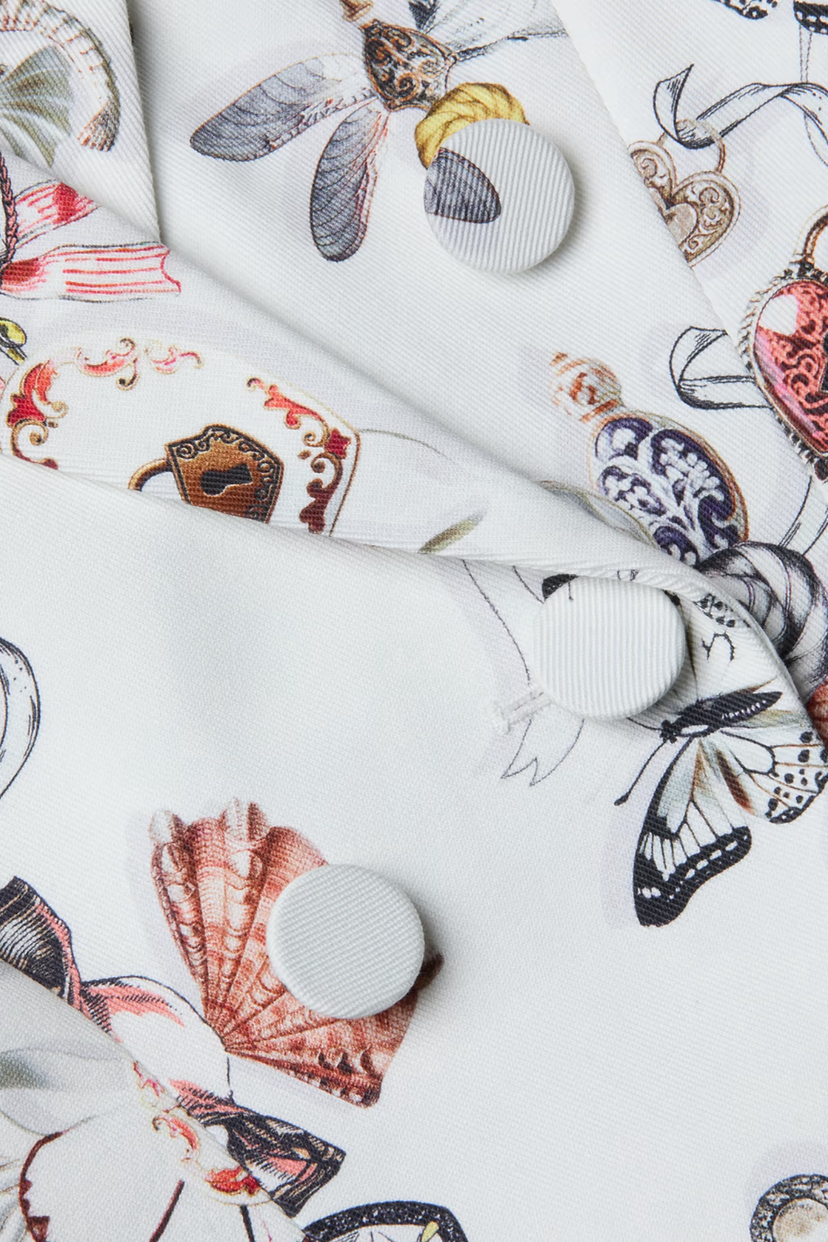 White ceramic plates with colorful butterfly designs on a white background