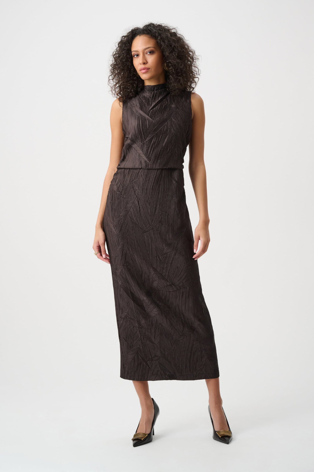 Woman wearing a dark brown dress on a white background