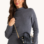 Black Hammitt Paul Mini crossbody bag worn with an evening outfit.