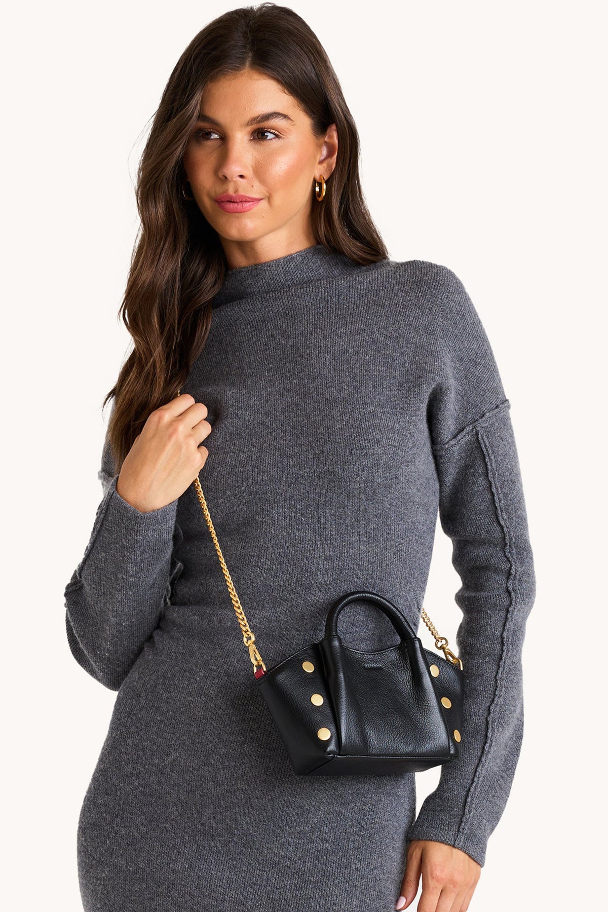 Black Hammitt Paul Mini crossbody bag worn with an evening outfit.