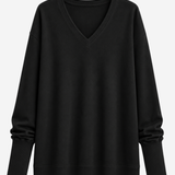 A black long-sleeve V-neck sweater with a relaxed, oversized fit, shown against a plain light gray background.