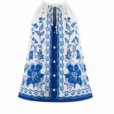 Blue and white floral dress with buttons on a white background