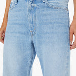 Light blue jeans worn by a person on a white background