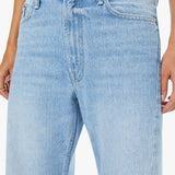 Light blue jeans worn by a person on a white background