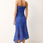 Woman wearing a blue lace dress on a white background