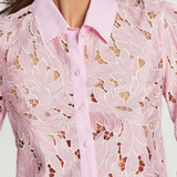Pink lace blouse with a white background