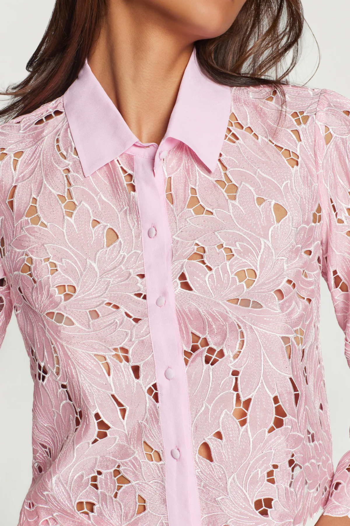 Pink lace blouse with a white background