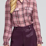 Women's plaid blouse featuring long sleeves, a relaxed silhouette, and multicolor pattern.