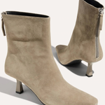 A pair of taupe suede ankle boots with pointed toes and kitten heels, shown from the side and back on a light beige background.