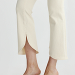 close up on scalloped cream denim and textured heels 