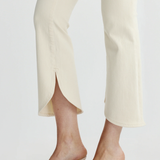 close up on scalloped cream denim and textured heels 