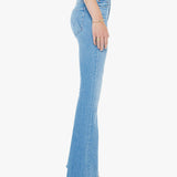 Light blue flared jeans worn by a person on a white background