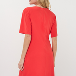 Woman wearing a red dress against a white background