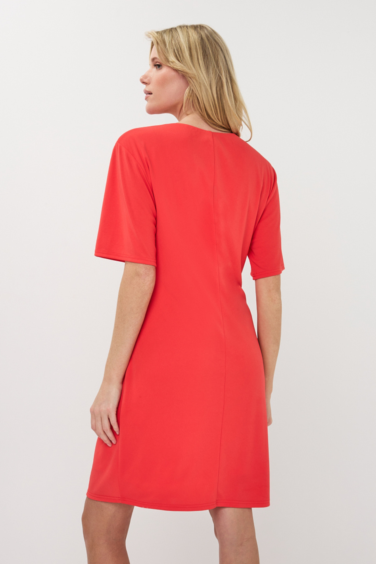 Woman wearing a red dress against a white background