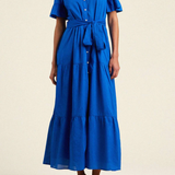 Woman wearing a blue dress on a beige background