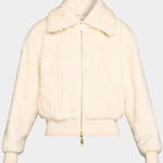 A cream-colored faux fur jacket with a gold zipper, shown against a light gray background.