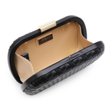 A black woven-texture clutch bag with a gold-tone metal clasp and a beige interior lining, shown open on a white background.