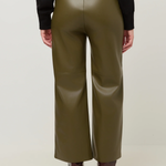 A person shown from the back wearing olive green wide-leg faux leather pants, a black long-sleeve top, and brown heeled ankle boots against a plain light background.
