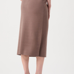 Person wearing a brown skirt on a white background