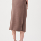 Person wearing a brown skirt on a white background