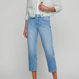 Person wearing a light gray textured jacket, white top, and blue jeans on a plain background