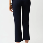 Person wearing navy blue pants on a white background