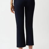 Person wearing navy blue pants on a white background