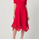 Elegant red dress with a fluid silhouette, styled for an evening setting.