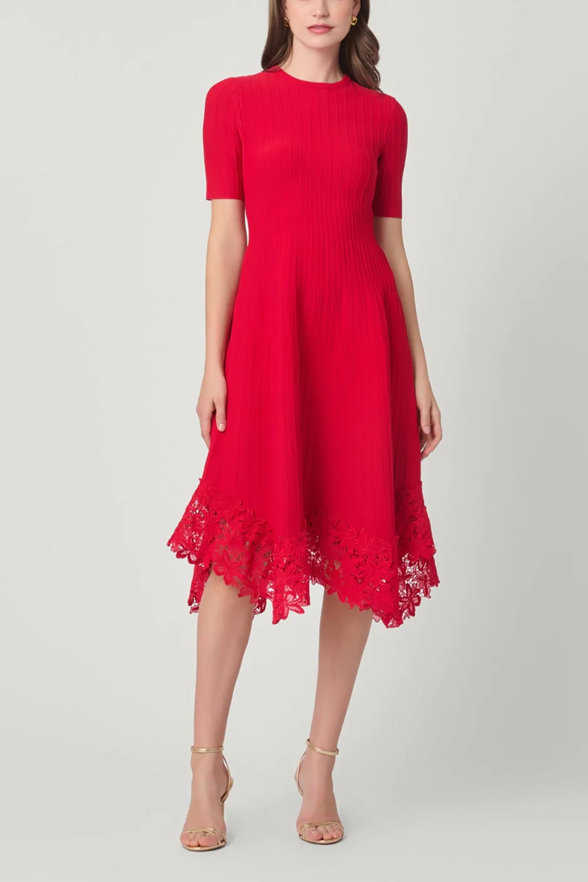 Elegant red dress with a fluid silhouette, styled for an evening setting.