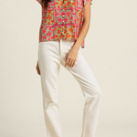 woman in floral blouse and white denim on white background 