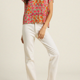 woman in floral blouse and white denim on white background 