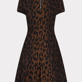 A short-sleeve fit-and-flare dress with a brown and black leopard print pattern, featuring a silver zipper at the back neckline, shown against a light gray background.