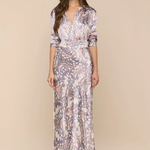 Woman wearing a floral patterned dress on a beige background