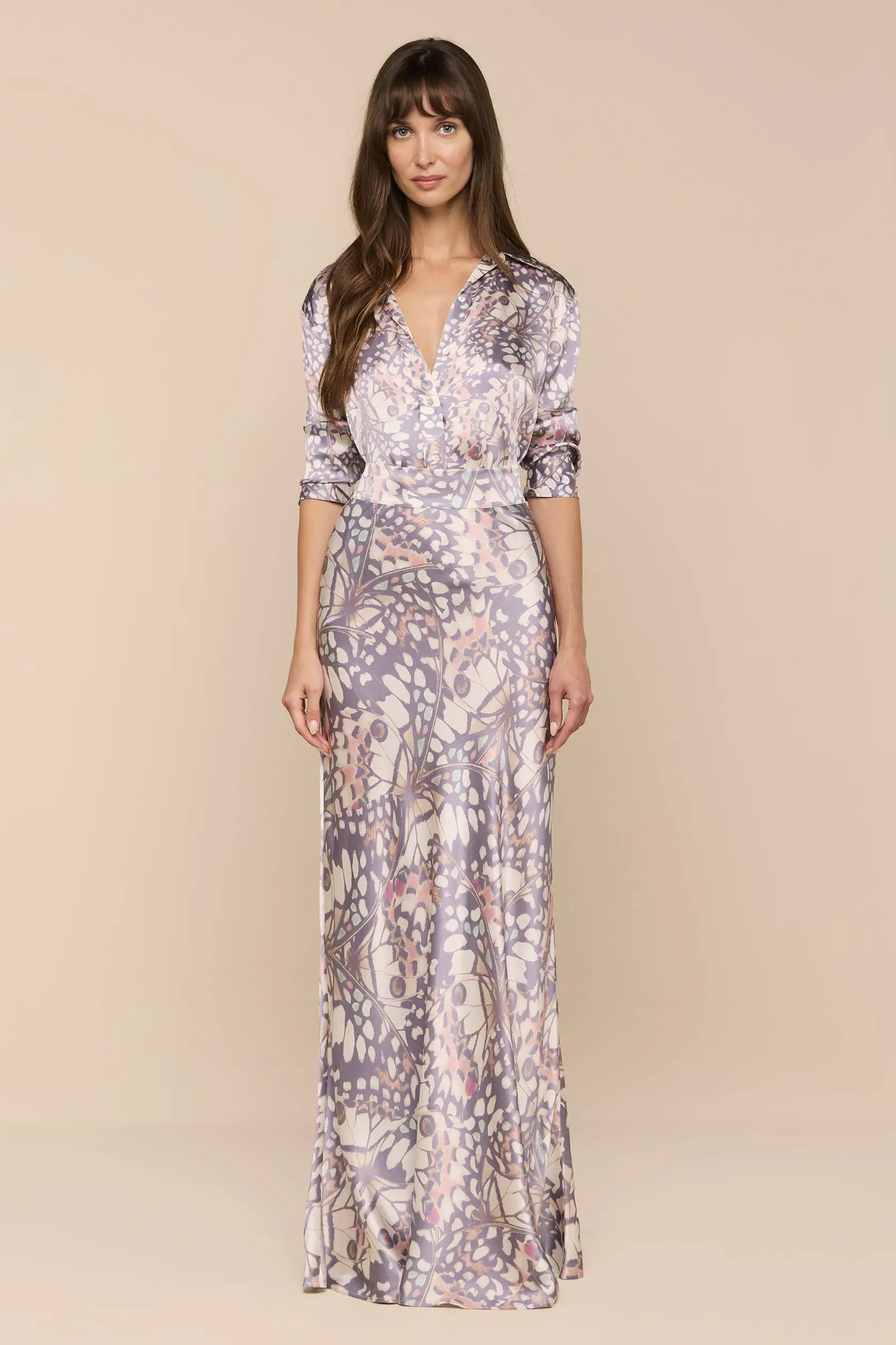 Woman wearing a floral patterned dress on a beige background