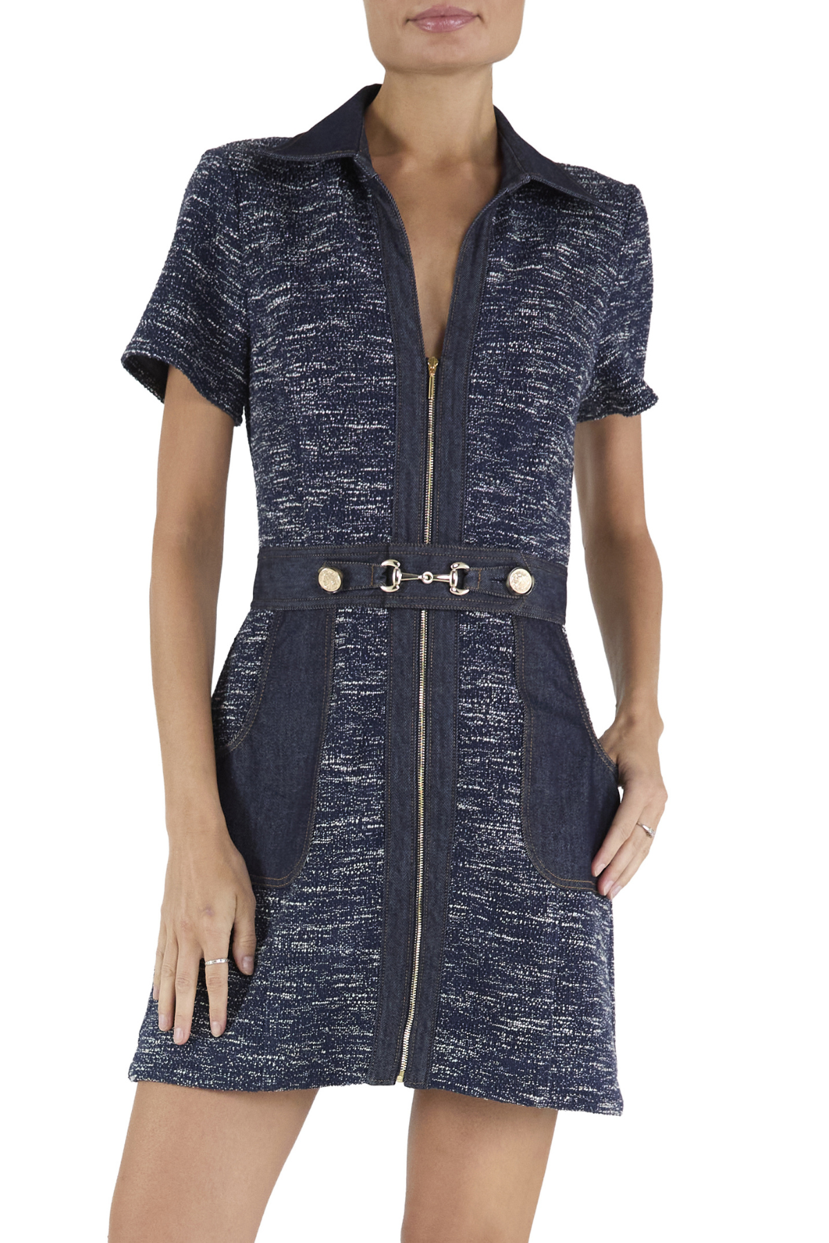 Woman wearing a navy blue dress with a belt on a white background