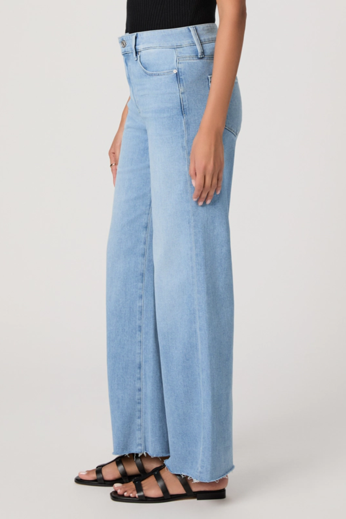 Light blue wide-leg jeans worn by a person on a plain background