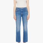 Woman wearing mid-wash cropped flare jeans with a slim upper fit and subtle kick-flare hem.