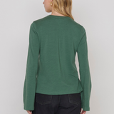 Women's green top featuring a keyhole neckline and feminine silhouette.