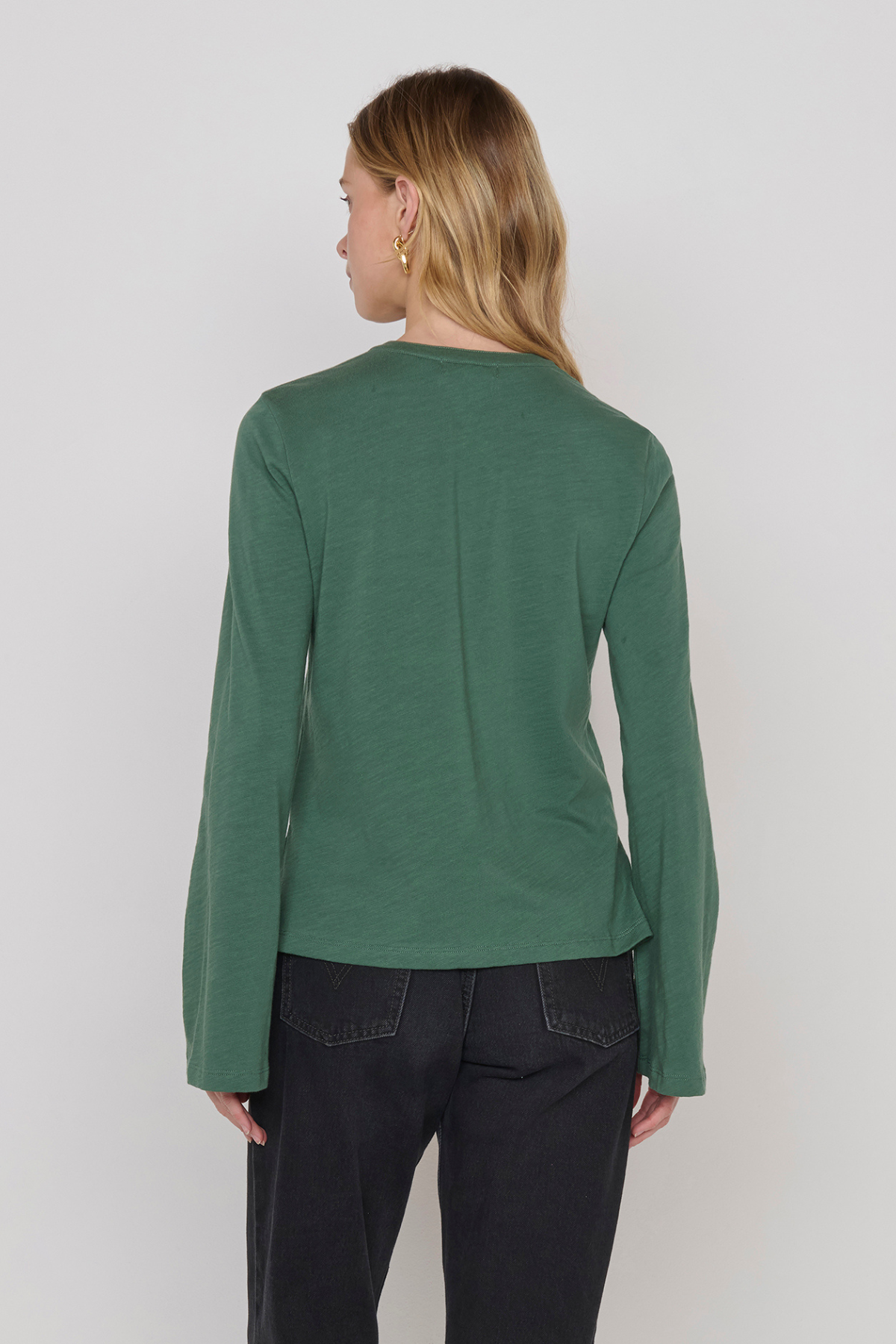 Women's green top featuring a keyhole neckline and feminine silhouette.