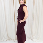 Coordinated burgundy pleated top and skirt set styled for a polished seasonal look