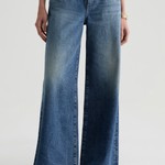 Model wearing high-rise wide-leg denim pants with a relaxed, full-length silhouette.