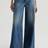 Model wearing high-rise wide-leg denim pants with a relaxed, full-length silhouette.