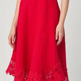 Elegant red dress with a fluid silhouette, styled for an evening setting.