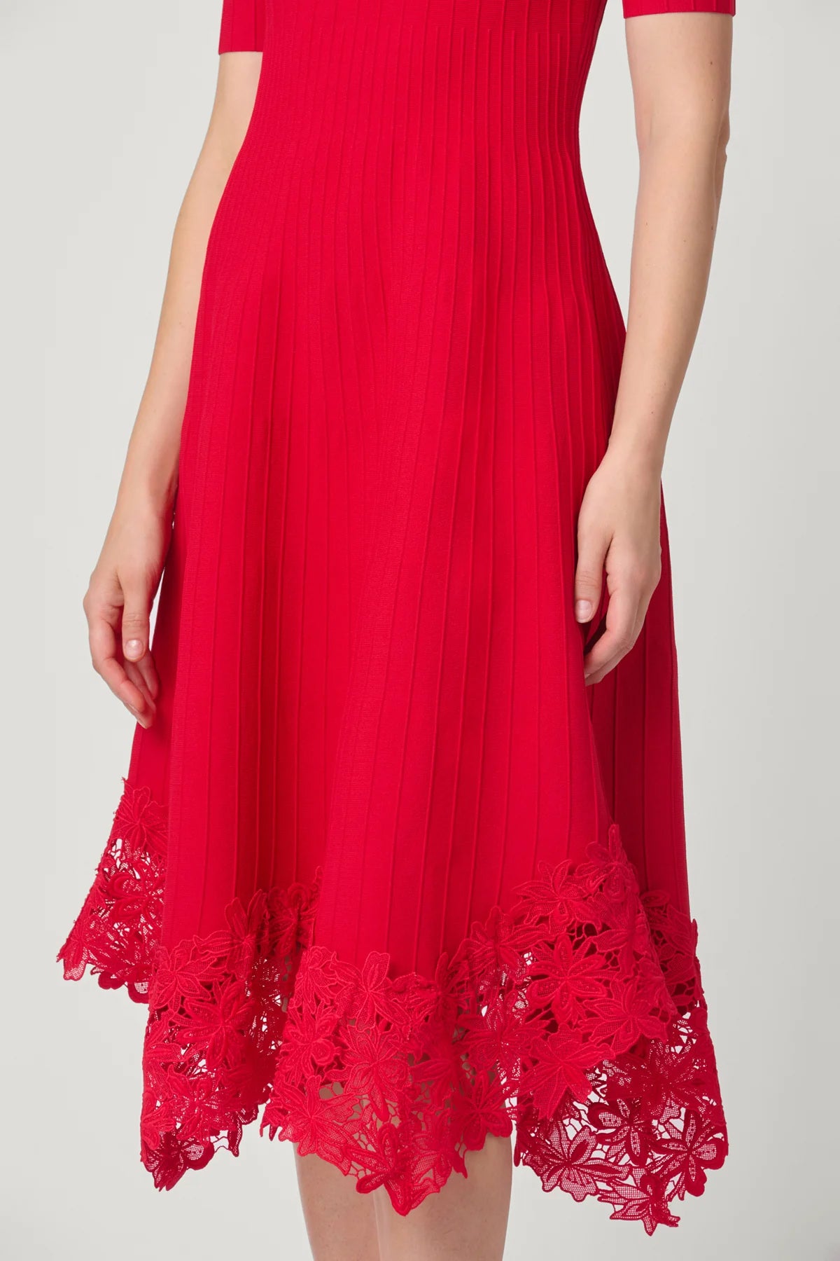 Elegant red dress with a fluid silhouette, styled for an evening setting.
