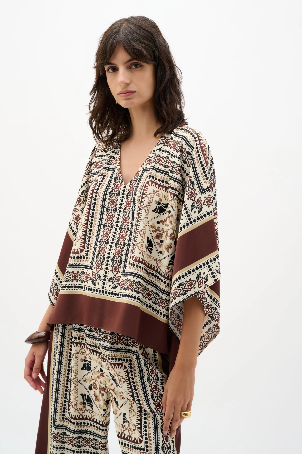 Woman wearing a patterned outfit on a white background